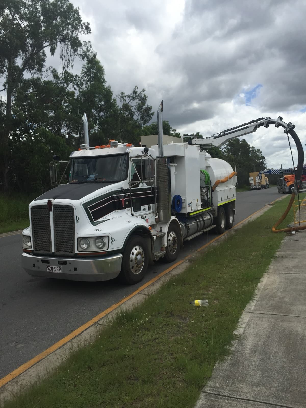 Real VACIT vacuum excavation truck with hose and boom positioned at a Queensland worksite