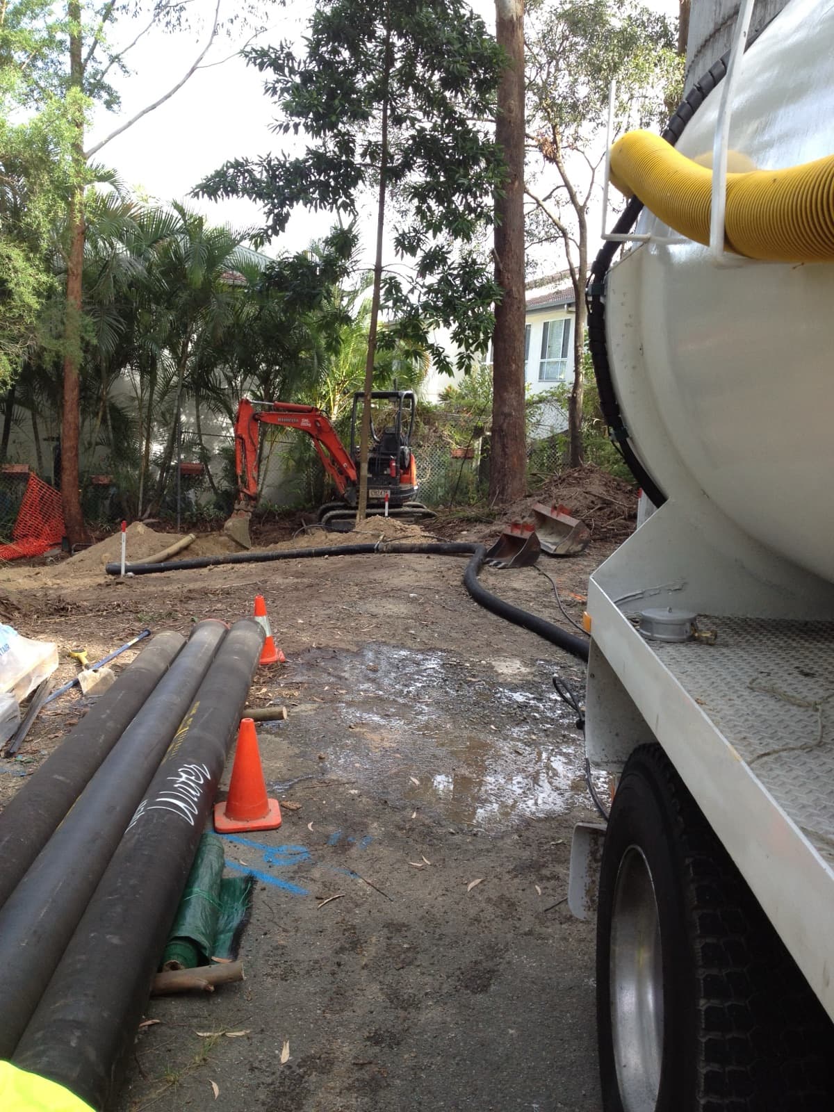 Vacuum excavation truck hose and pipework laid out at a real VACIT civil worksite