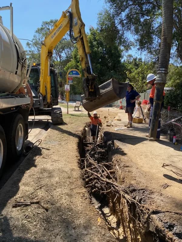 VACIT crew working beside an exposed trench and vacuum truck